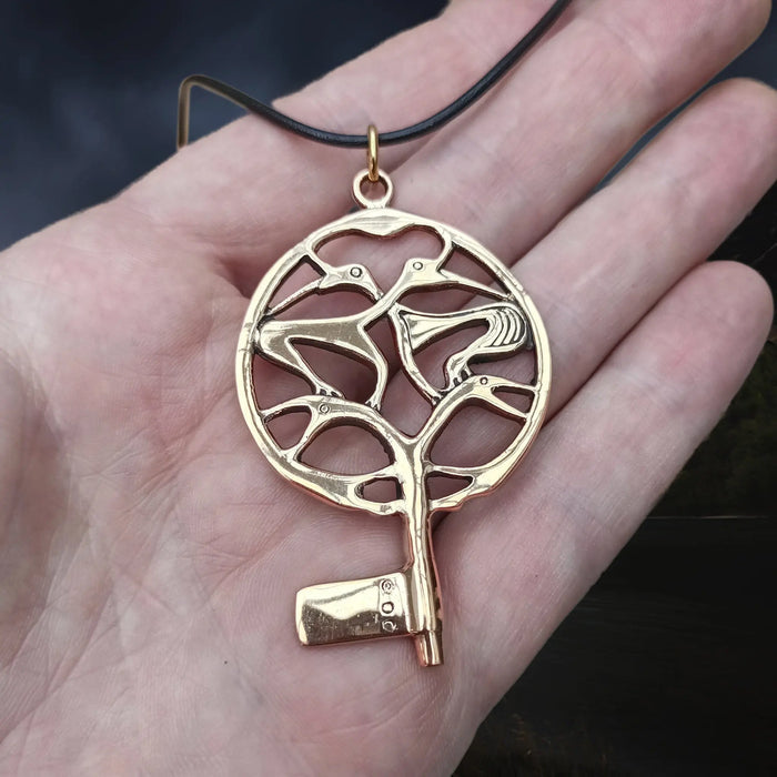 Bronze Large Round Viking Key Pendant from Uppakra on Hand on Leather Thong