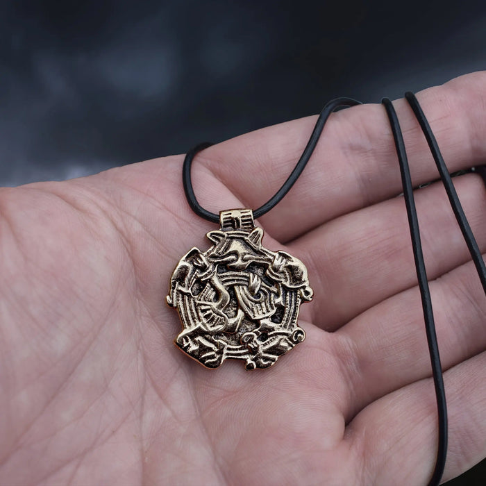 Solid Bronze Replica Viking Gripping Beats Pendant from&nbsp; 10th century Sweden on Leather Cord Wrapped Around Hand