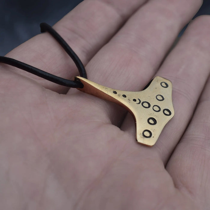 Bronze Replica Thors Hammer Pendant from 10th Century Denmark with Dot & Ring Design on Leather Cord, on Hand - Side Angle View