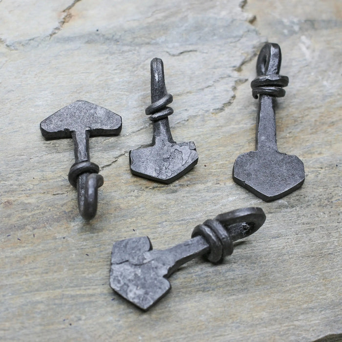 Small Iron Thors Hammer Pendants on Rock