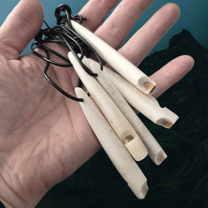 Handmade Replica Viking Age Bone Whistles with Wooden Block on Leather Cords on Hand