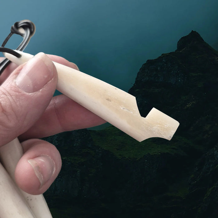 Handmade Replica Viking Age Bone Whistle with Wooden Block on Leather Cord in Hand - Side View
