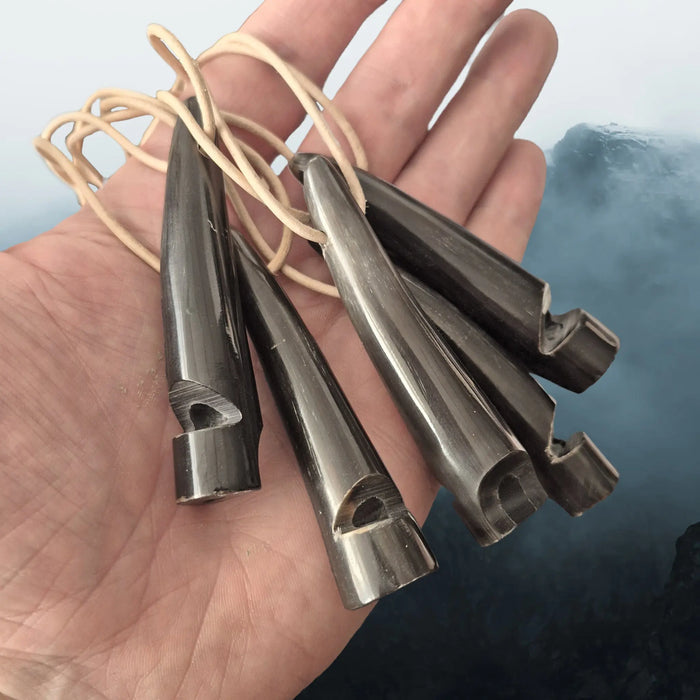 Handmade Replica Viking Age Dark Horn Whistles with Horn Block from Öland, Sweden on Natural Leather Cords on Hand - Angle View