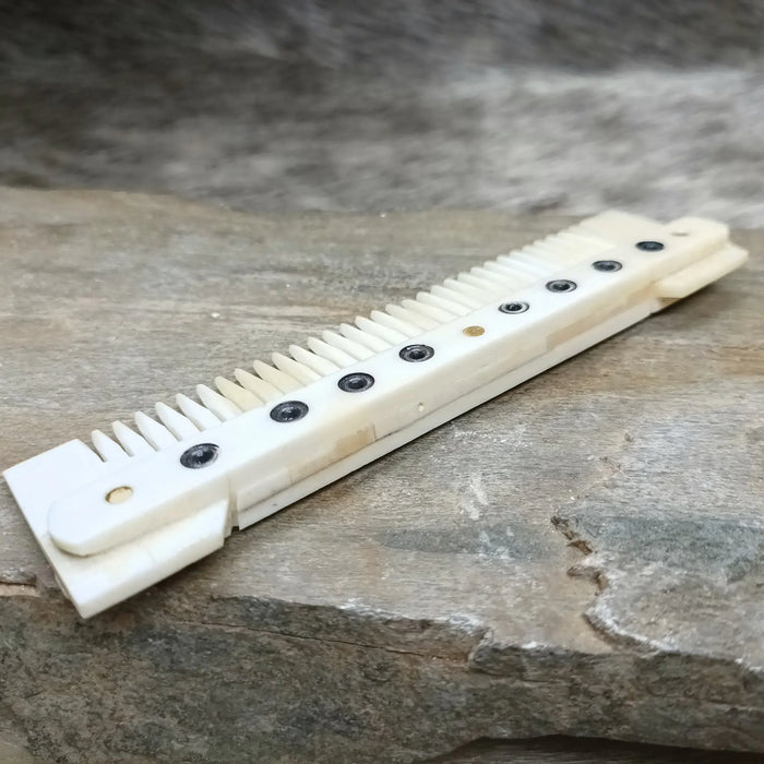 Medium Decorated Bone Viking Comb on Rock - Back View